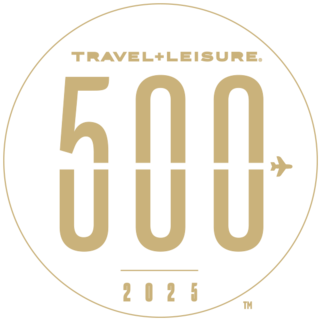 Logo featuring "TRAVEL+LEISURE," "500," and "2025," with a plane icon, all designed in a gold circular format.